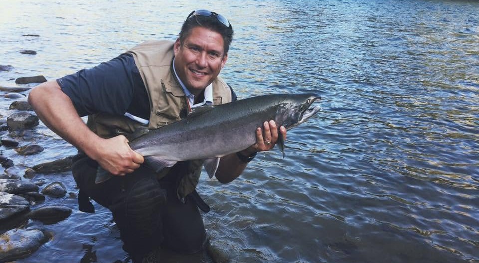 Dana Gorbahn holding a salmon caught while fishing